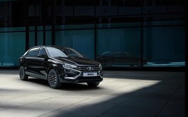 ВАЗ (Lada) Aura седан: вид спереди сбоку у здания