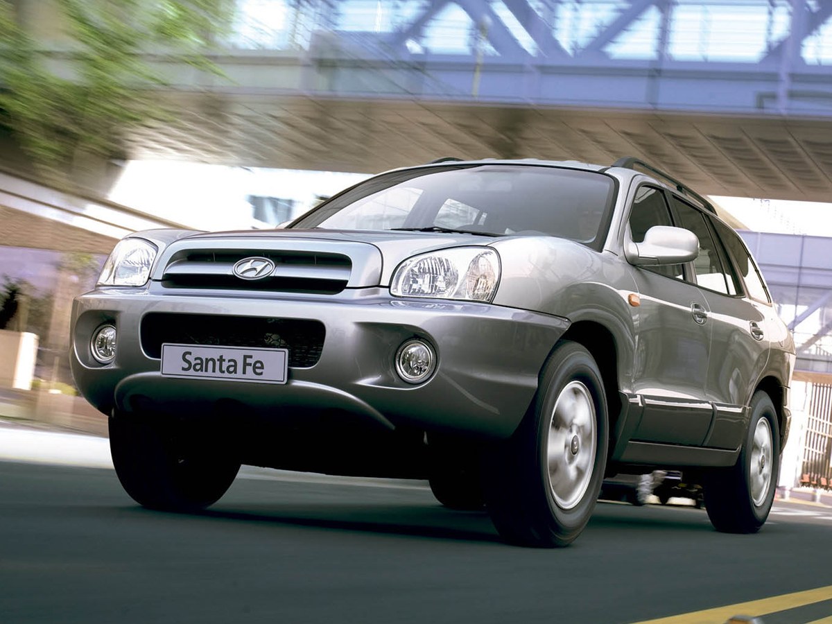 Hyundai Santa Fe Classic (I поколение, 2007 - 2012 г.в.): Серебристый кроссовер под мостом, вид спереди сбоку
