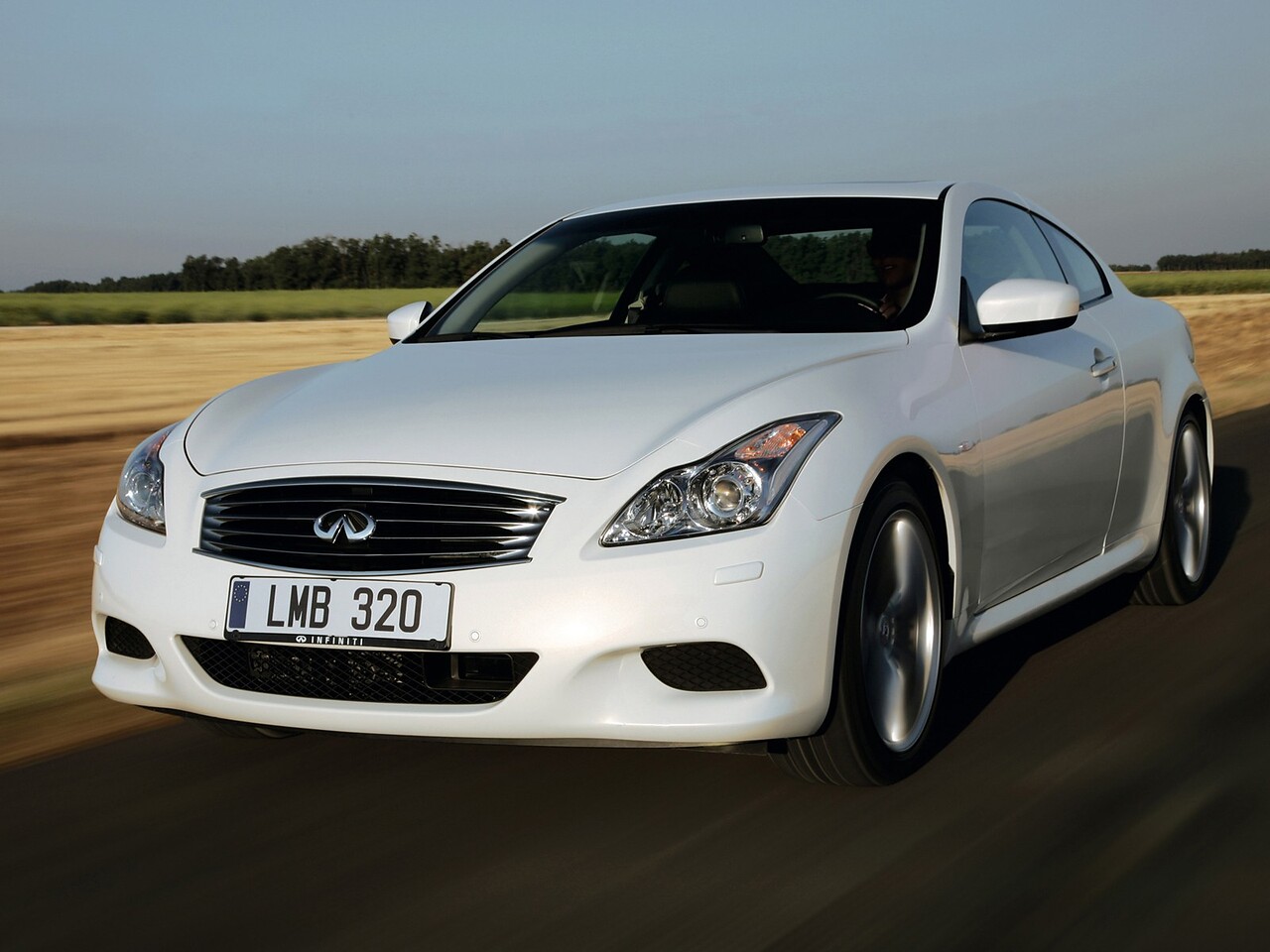 Infiniti G купе (II поколение, 2008 - 2013 г.в.): Белое купе в движении, вид спереди сбоку
