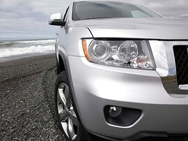 Jeep Grand Cherokee (WK2, 2010 - 2013 г.в.): Крупный план передней фары и колеса у воды