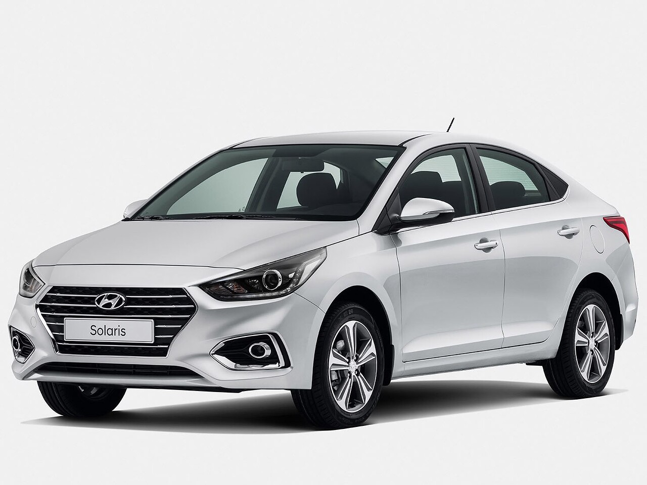 Hyundai Solaris седан (II поколение, 2017 - 2020 г.в.): Серебристый седан в студии, вид спереди сбоку