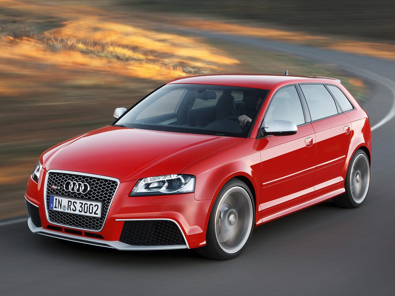 Audi RS3 хэтчбек 5-дв. 2.5 TFSI quattro AT: Три четверти спереди на закате, красный кузов